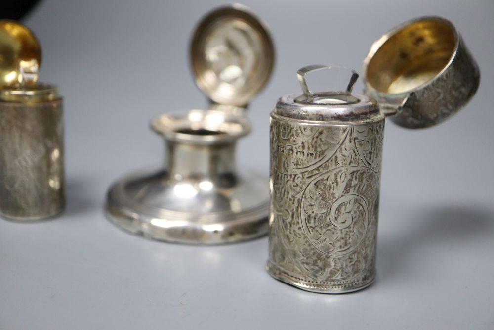 A silver capstan inkwell and two silver-cased cylindrical scent bottles